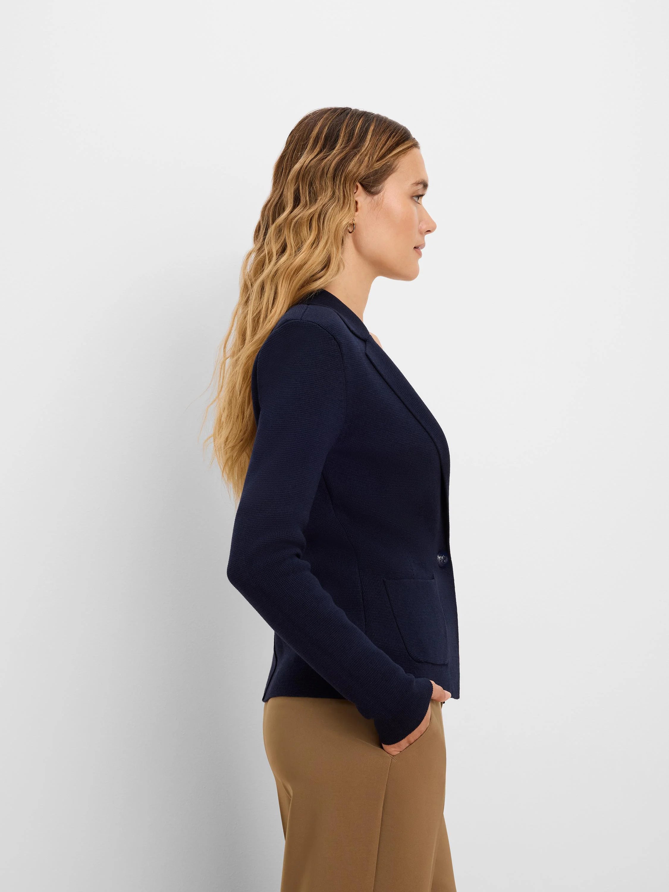 Navy knit tailored blazer with lapels, a single button closure, and two front patch pockets.