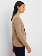 Camel knit blazer with notched lapels, one button, and a patch pocket, worn by a woman.