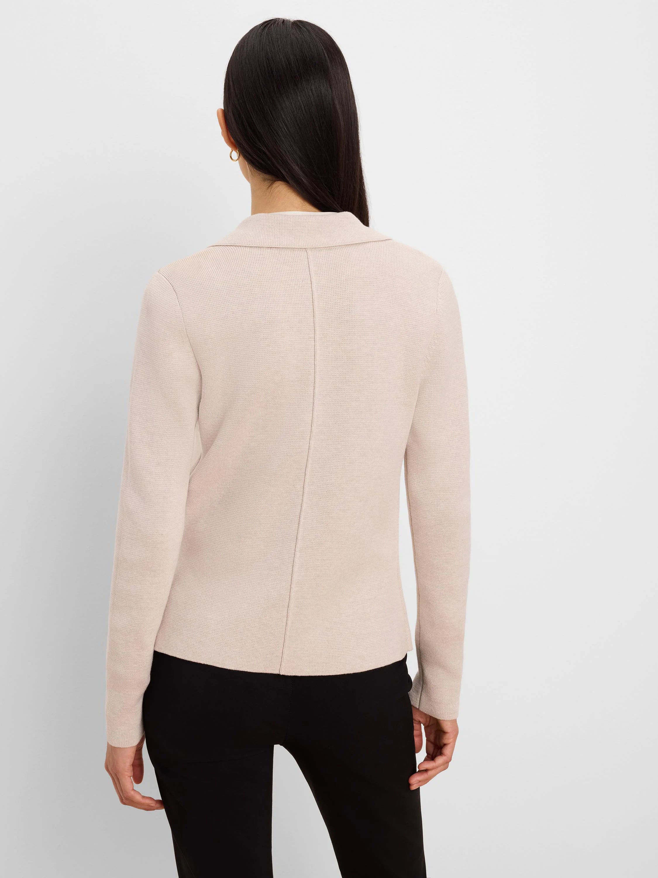 Light beige knit blazer, back view. Shows tailored collar and vertical back seam.