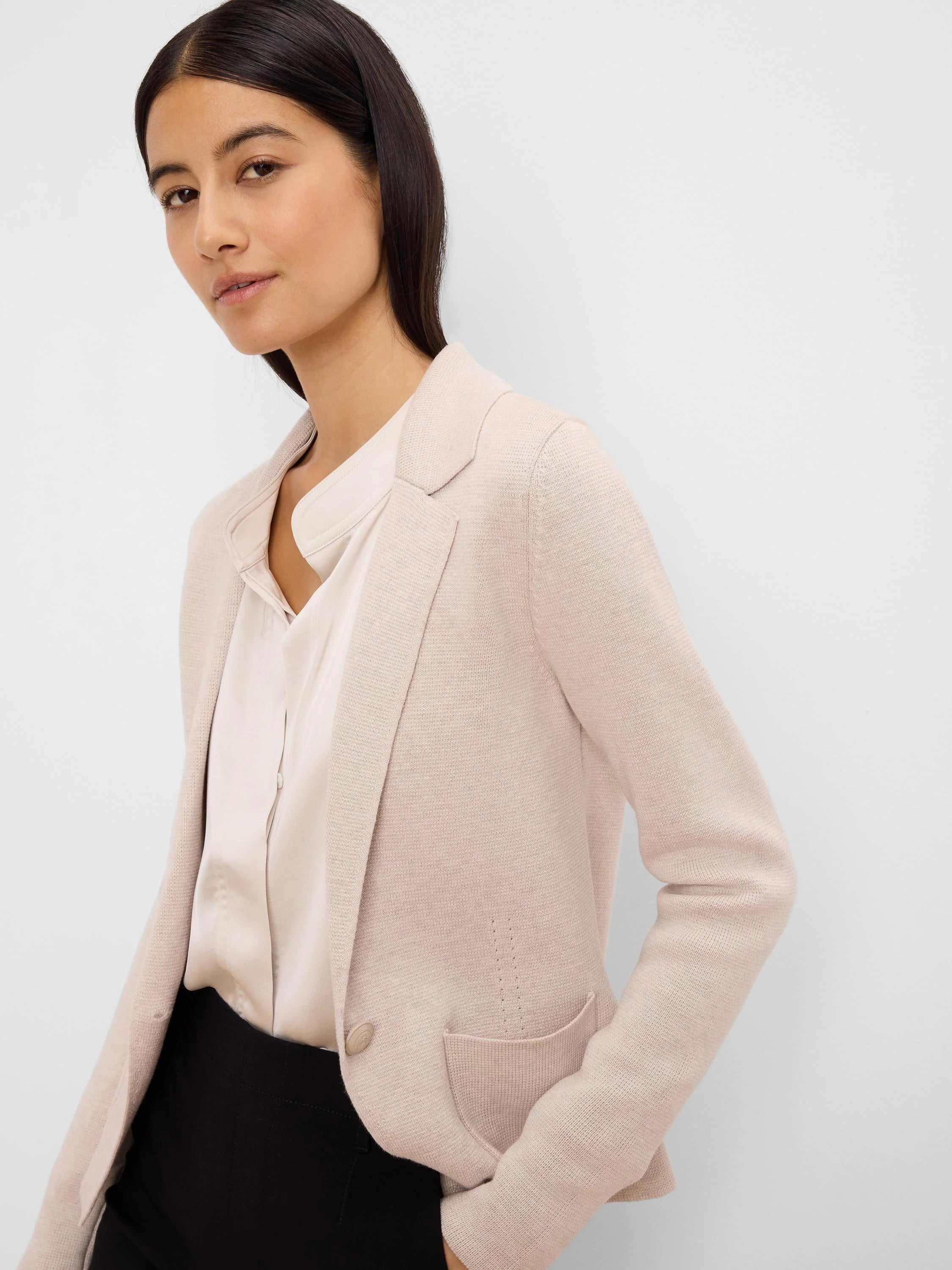 Blush knit blazer with notched lapels, a single button closure, and front patch pockets.