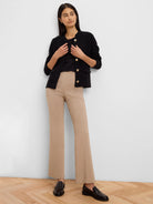 Black knit jacket with a collarless neckline, gold buttons, and black trim details.