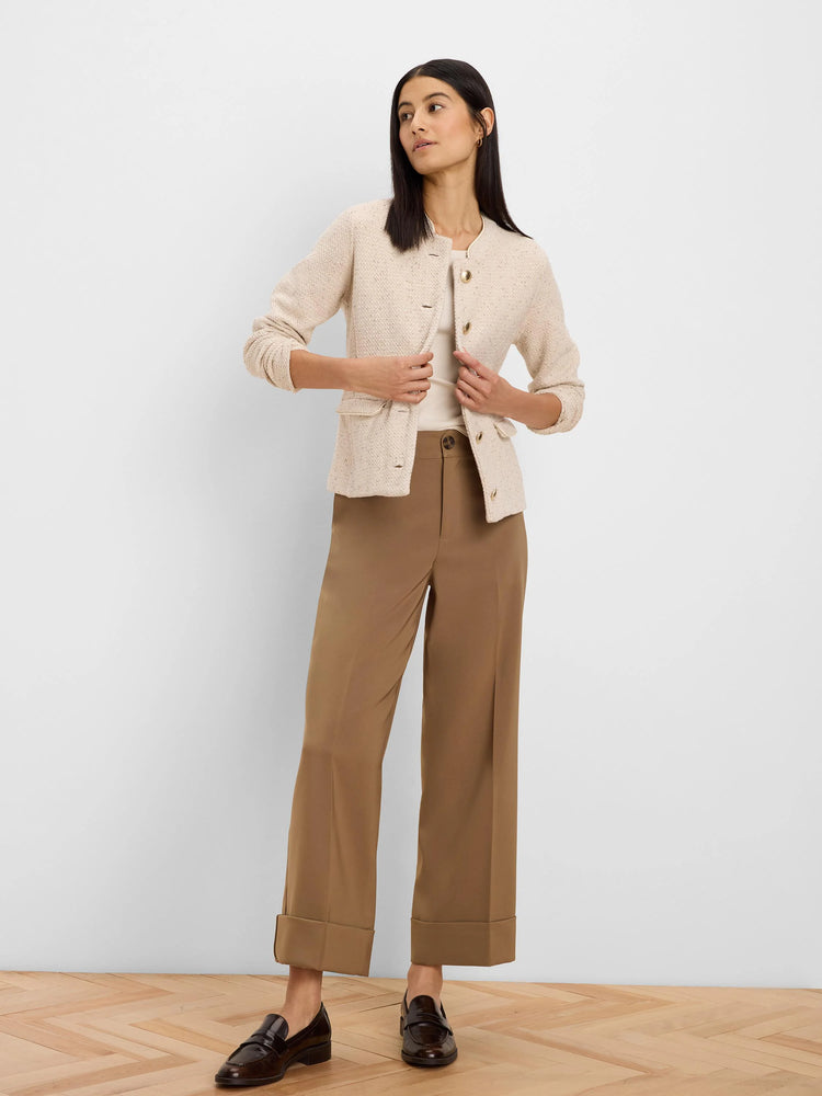 Cream weave knit jacket. Collarless, gold buttons, two flap pockets, and subtle trim.
