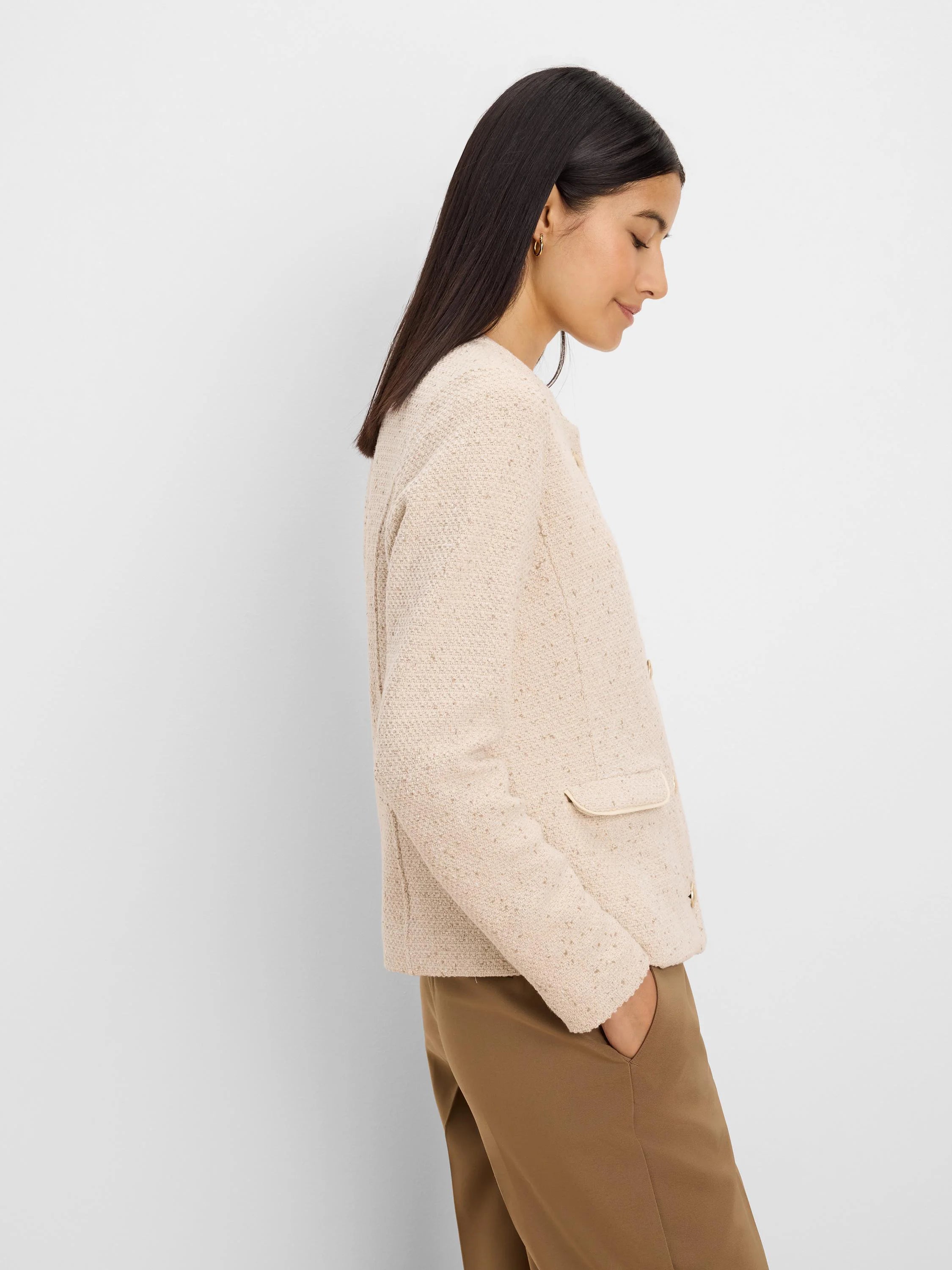 Cream weave mix knit jacket with subtle brown flecks, collarless design, and two front patch pockets.
