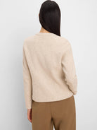 Light beige collarless jacket with a flecked knit weave. Back view.