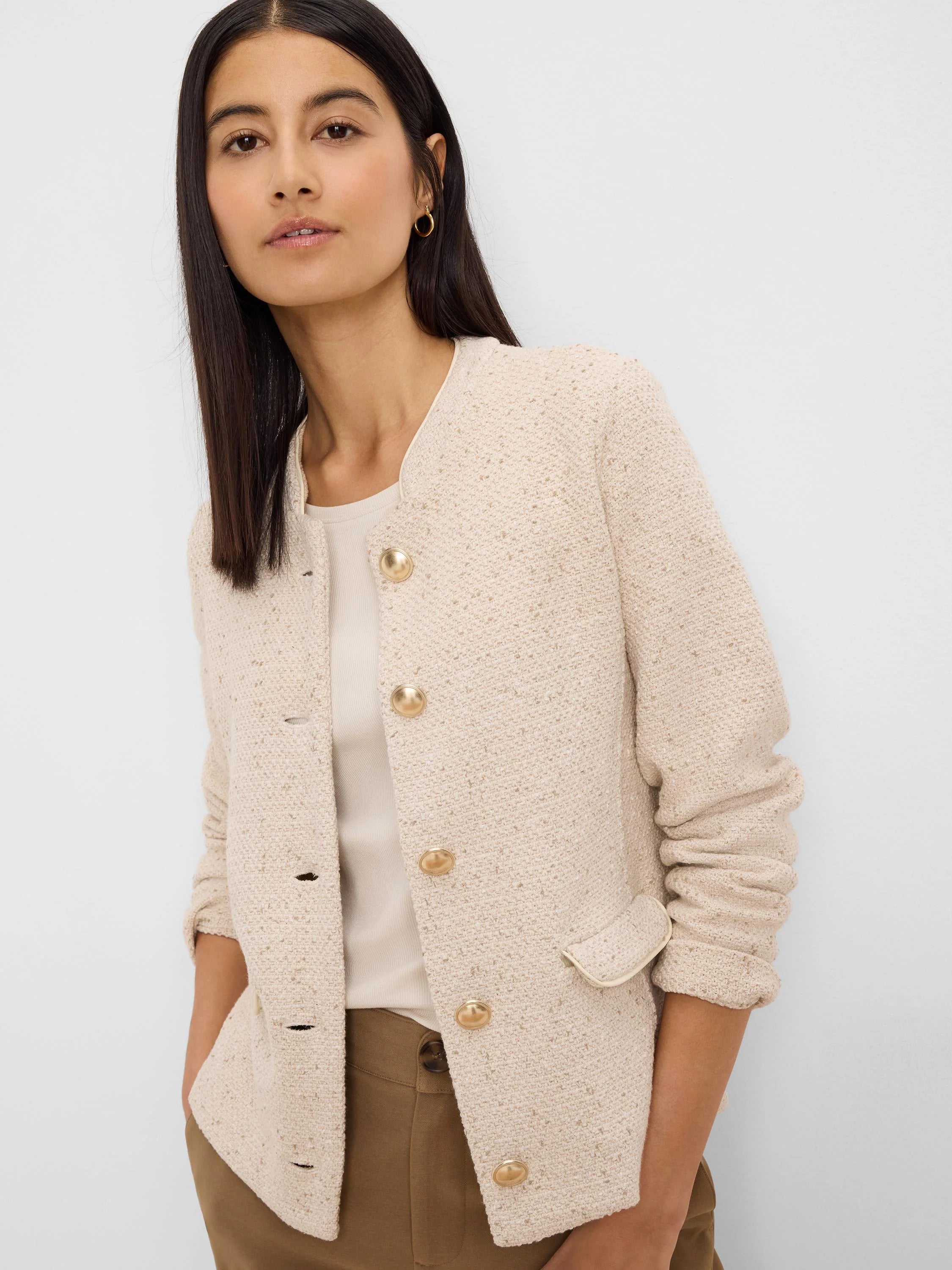 Cream weave mix knit jacket with solid trim, round neck, gold buttons, and front patch pockets.