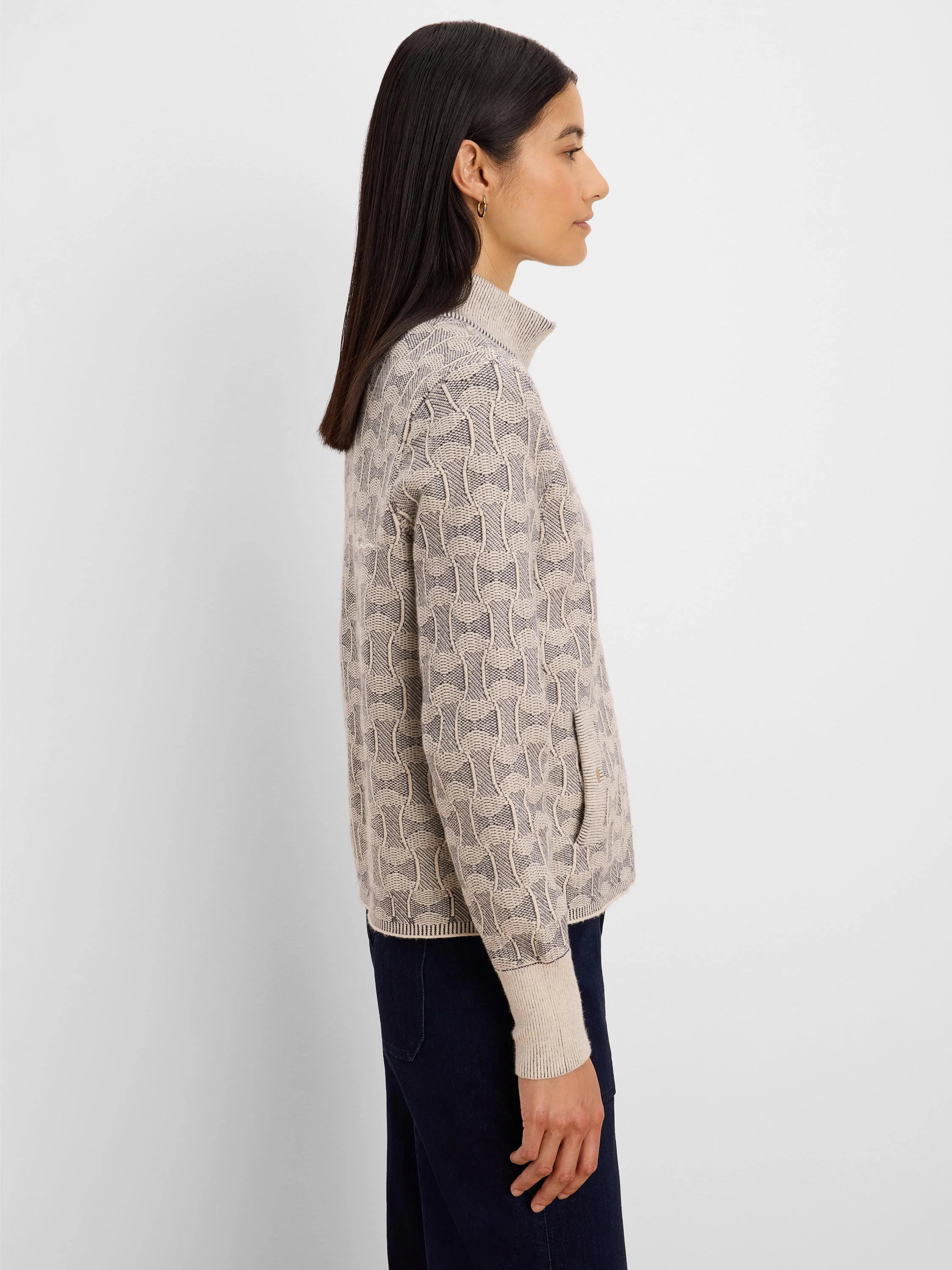 Cream and charcoal knit jacket with swirling textured pattern, mock neck, ribbed cuffs, and side pockets.