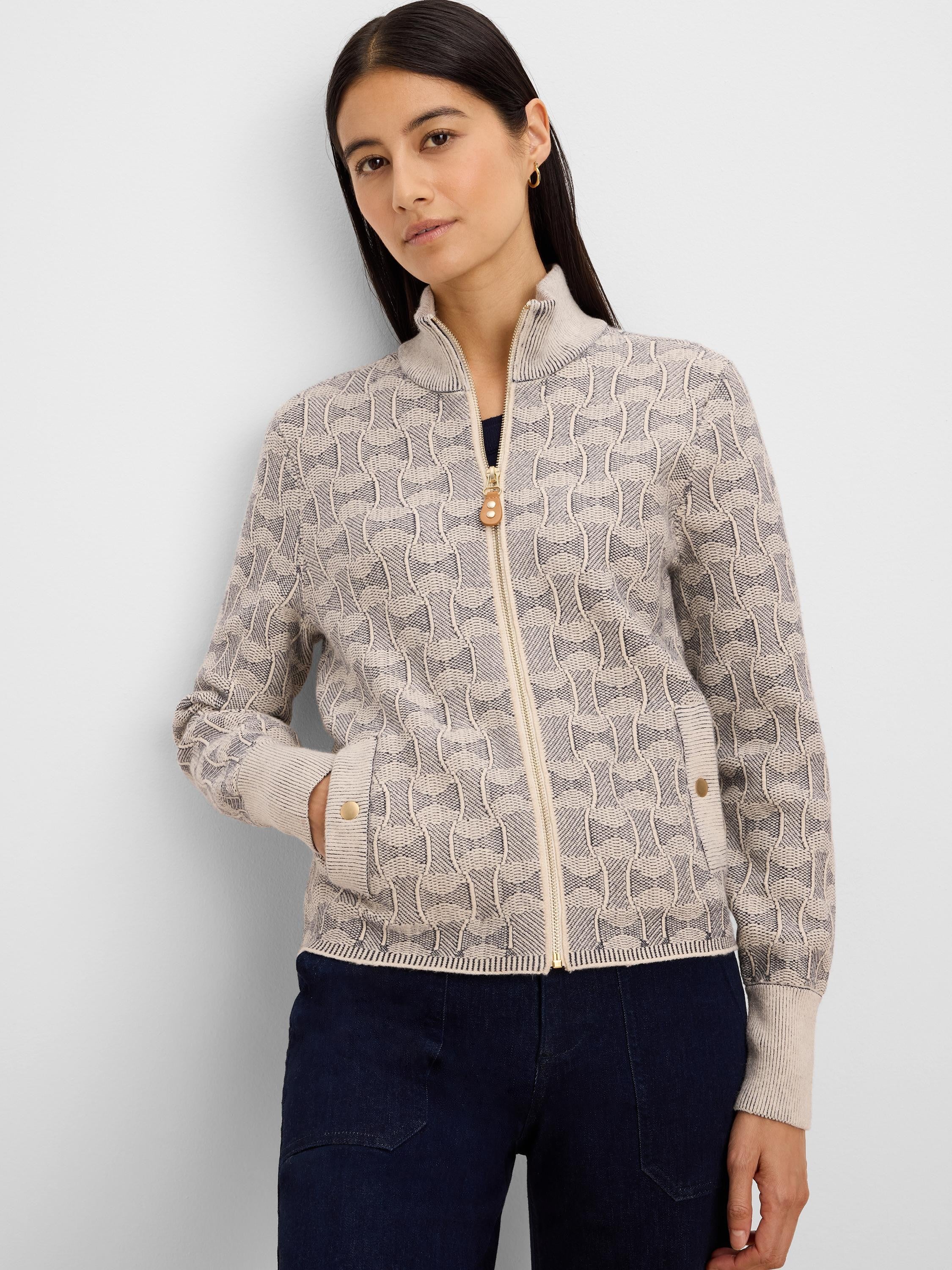 Cream knit jacket with dark grey swirl pattern. Features gold full-zip, stand collar, ribbed cuffs & hem, and gold-button...