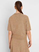 Tan sequin knit polo sweater with short sleeves and collar, featuring tiny shimmering sequins throughout. Back view.