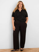 Black short-sleeve polo sweater with a V-neck, covered in subtle scattered sequins.