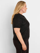 Black short-sleeve polo sweater, covered in small, reflective black sequins.