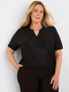 Black short-sleeve sequin sweater with polo collar and V-neck.