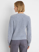 Light blue flecked shaker knit sweater with cable textured sleeves.