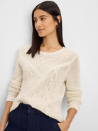 Ecru sweater with a mix of open and close knit patterns, featuring a distinct V-shape on the front.