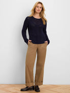 Navy blue sweater with mixed diamond and open-knit patterns, rounded hem, and long sleeves.