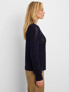 Navy blue mixed-stitch sweater. Features open knit upper, and diamond stitch on lower body and sleeves.
