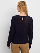 Dark navy blue long-sleeve sweater with mixed diamond stitch knit texture and a keyhole cutout on the upper back.