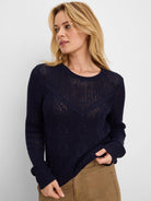 Navy blue sweater with open knit upper, diamond stitch cable patterns on body & sleeves.