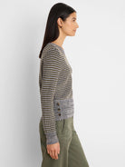 Grey, black, and yellow-green marled open-knit sweater with a ribbed side tuck detail featuring 3 brown buttons.
