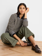 Black, grey, yellow marled sweater with open grid knit, black polo collar, and long sleeves.