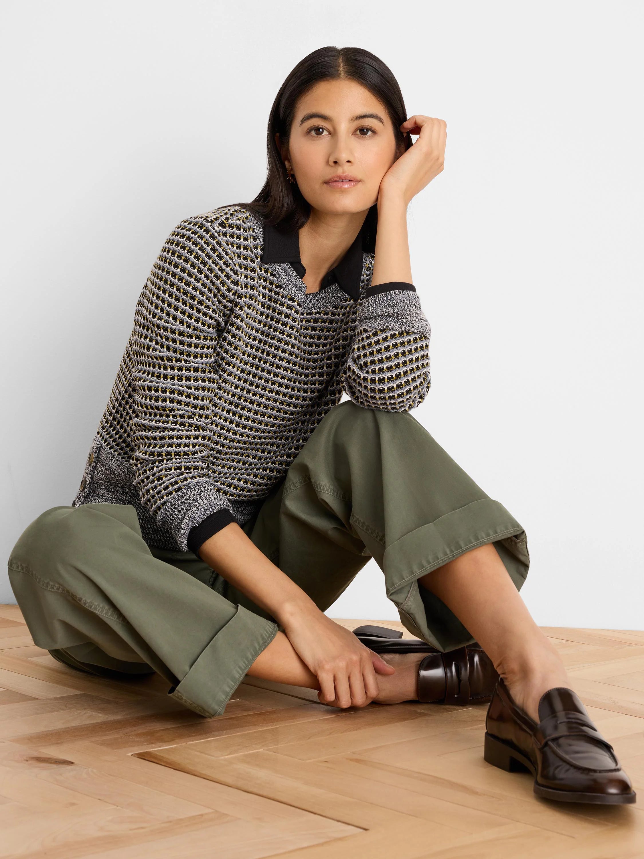 Black, grey, yellow marled sweater with open grid knit, black polo collar, and long sleeves.