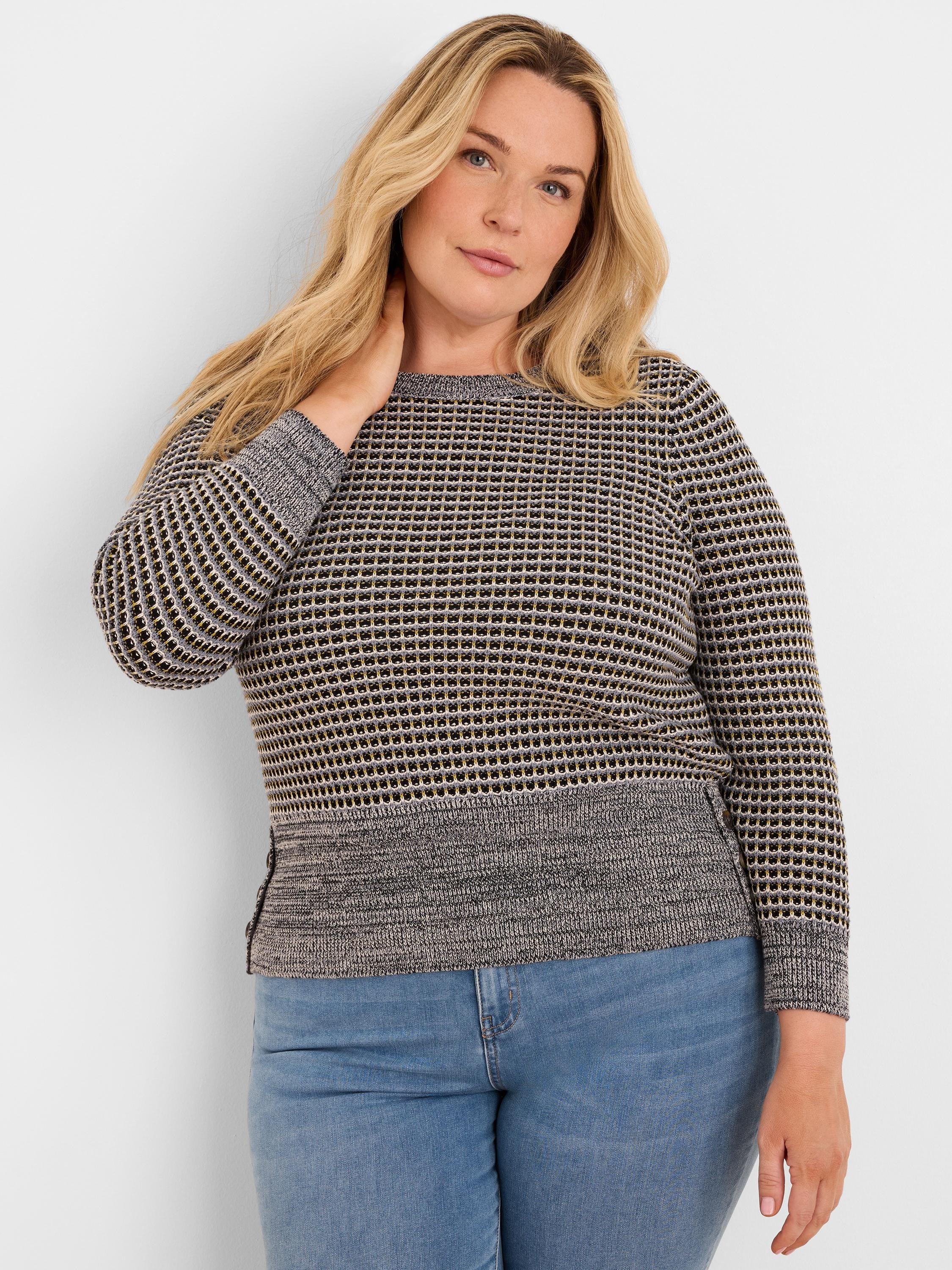 Marled grey crew neck sweater with a textured grid pattern in black, light grey, and yellow; solid grey lower hem.
