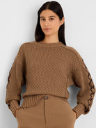 Brown textured sweater with dark brown criss-cross pattern on sleeves.