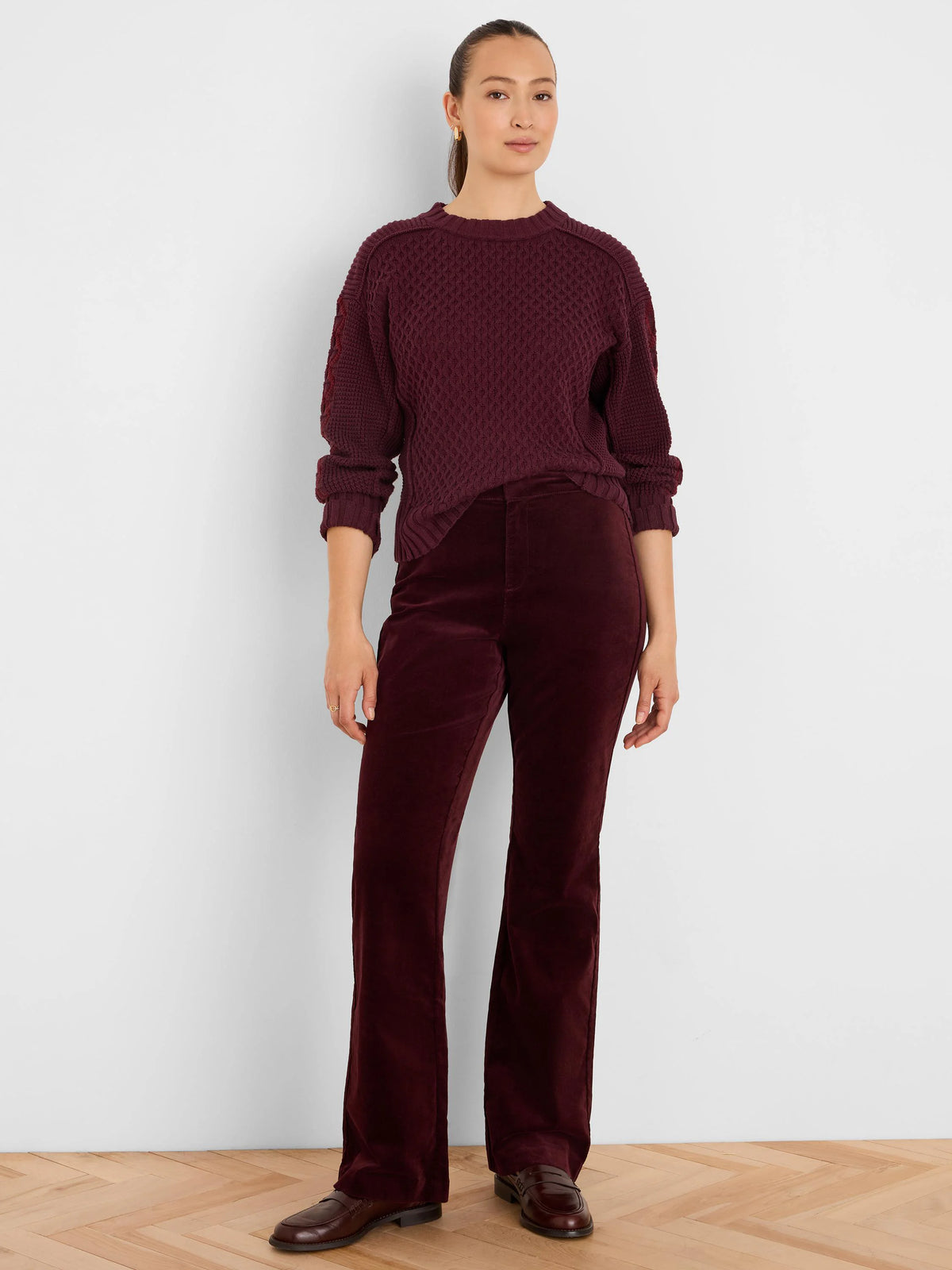 Deep red sweater with a textured criss-cross knit pattern.