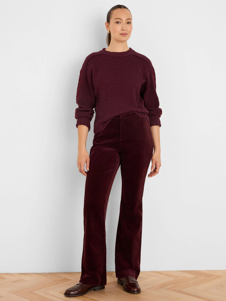 Deep red sweater with a textured criss-cross knit pattern.