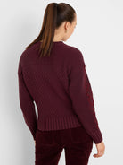 Deep red sweater with criss-cross knit pattern on body and sleeves, featuring ribbed collar, cuffs, and hem.