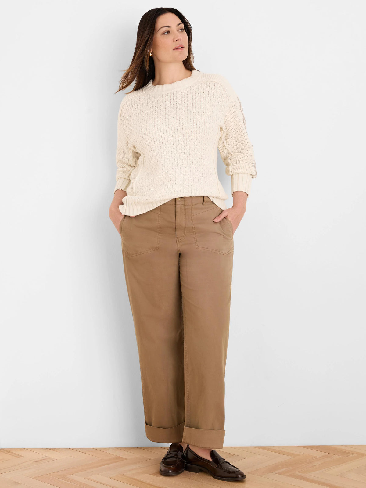 Off-white cable knit sweater with a textured criss-cross pattern on the front and sleeves.