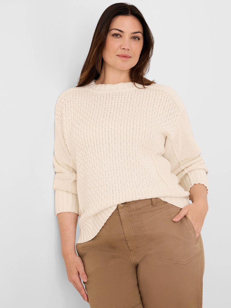 Off-white, loose-fitting criss cross sweater with a varied textured knit, crew neck, and ribbed cuffs/hem.