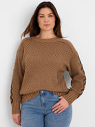 Tan brown textured knit sweater with a dark brown criss-cross pattern on the sleeves.