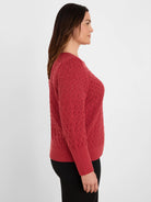 Rust red sweater with textured diamond stitch, long sleeves, ribbed cuffs and hem.