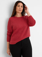 Rusty red sweater with openwork diamond knit pattern, crew neck, and ribbed cuffs and hem.