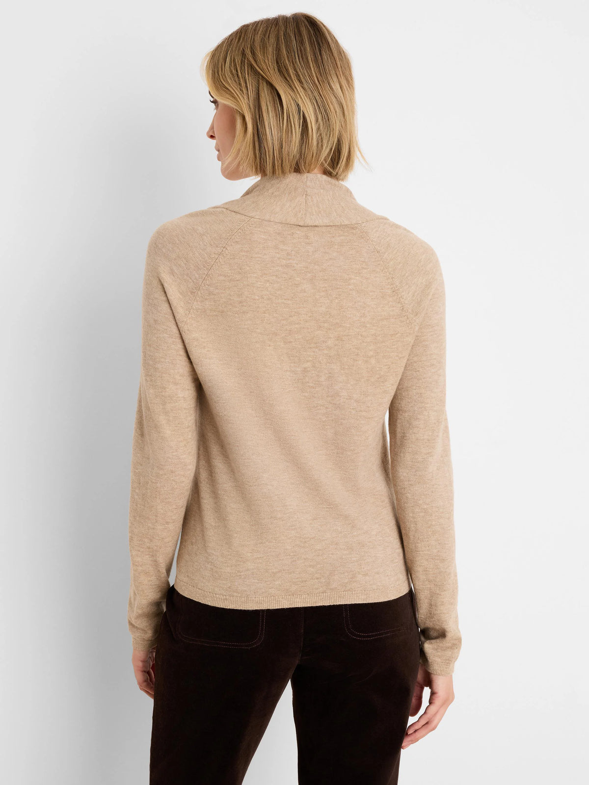 Beige fine knit sweater with a high, soft collar and raglan sleeves, shown from the back.