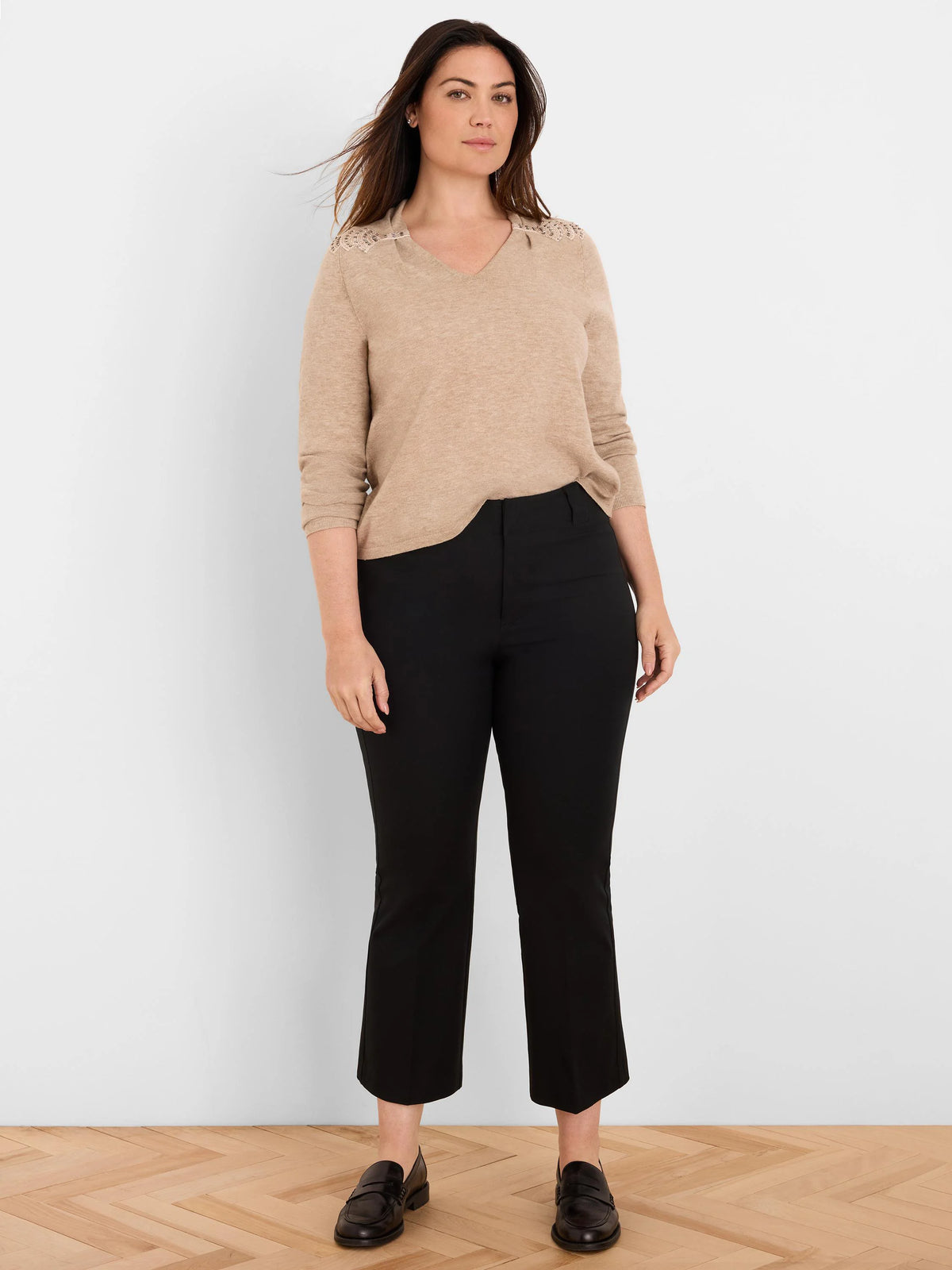 Light tan V-neck sweater with shimmering beaded shoulders and long sleeves.