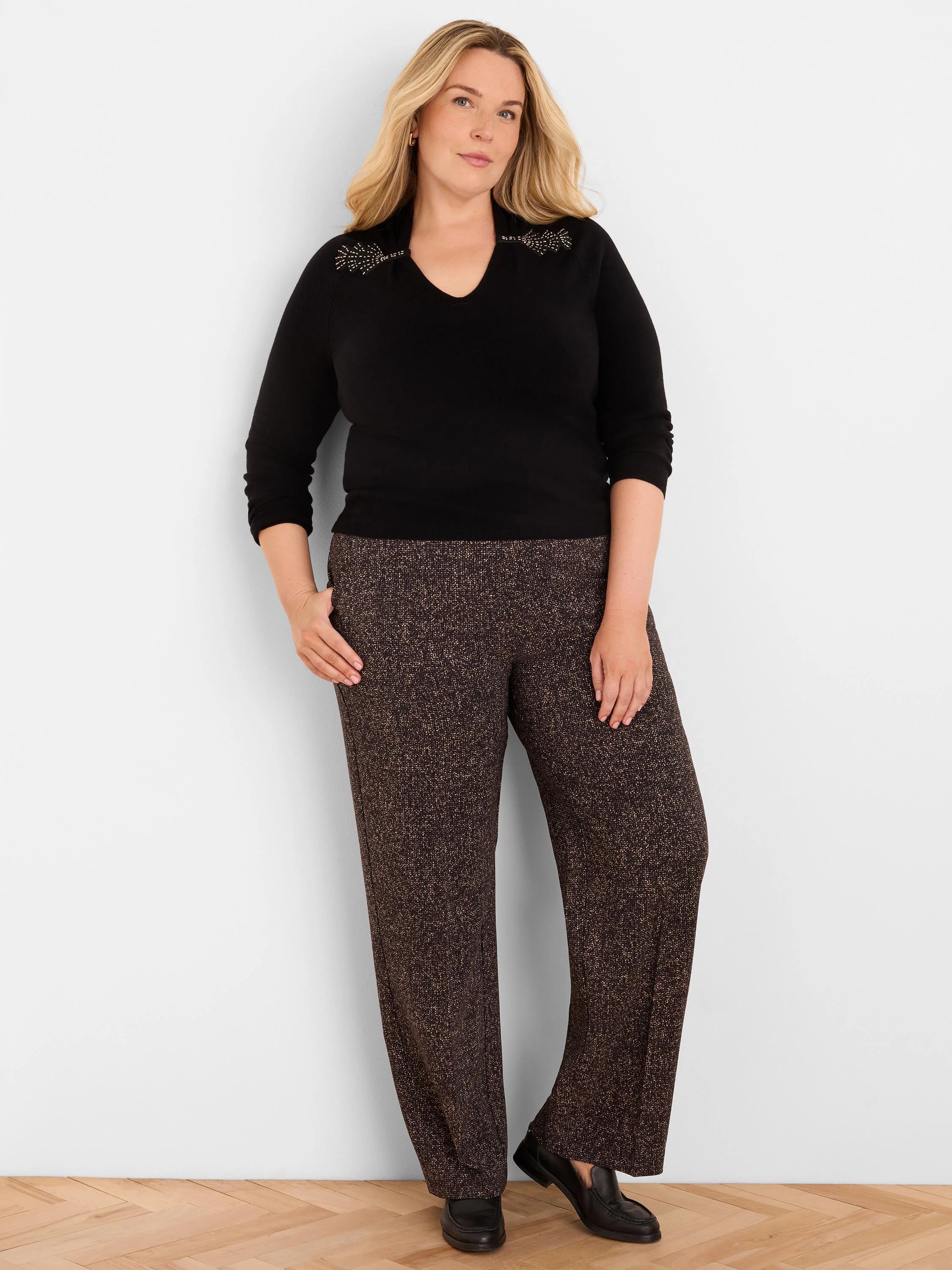 Black V-neck sweater with gold beaded embellishments on the shoulders.