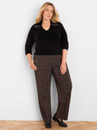 Black V-neck sweater with gold beaded embellishments on the shoulders.