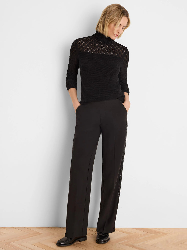 Black knit turtleneck sweater. Diamond lace pattern on shoulders/upper sleeves, solid knit torso. 3/4 length sleeves.