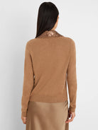 Back view of a tan knit cardigan with a bronze sequin collar.