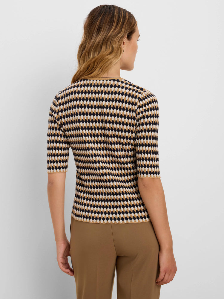 Angled jacquard sweater with dark navy, cream, and camel diamond pattern and elbow sleeves.
