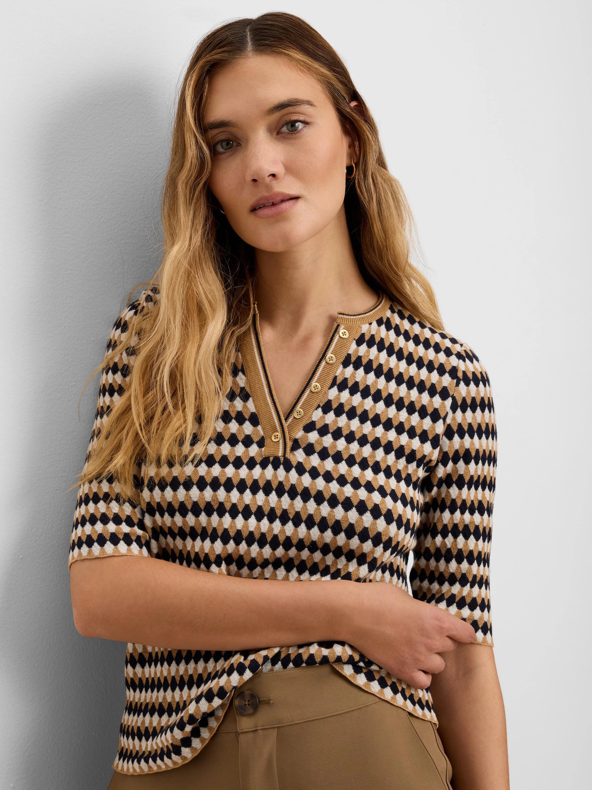 Navy, cream, & tan angled jacquard sweater with diamond pattern. Short-sleeved V-neck, button-front placket.