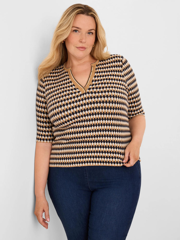 Angled jacquard sweater with black, tan, & beige diamond pattern. Features a V-neck with gold buttons & elbow-length sleeves.