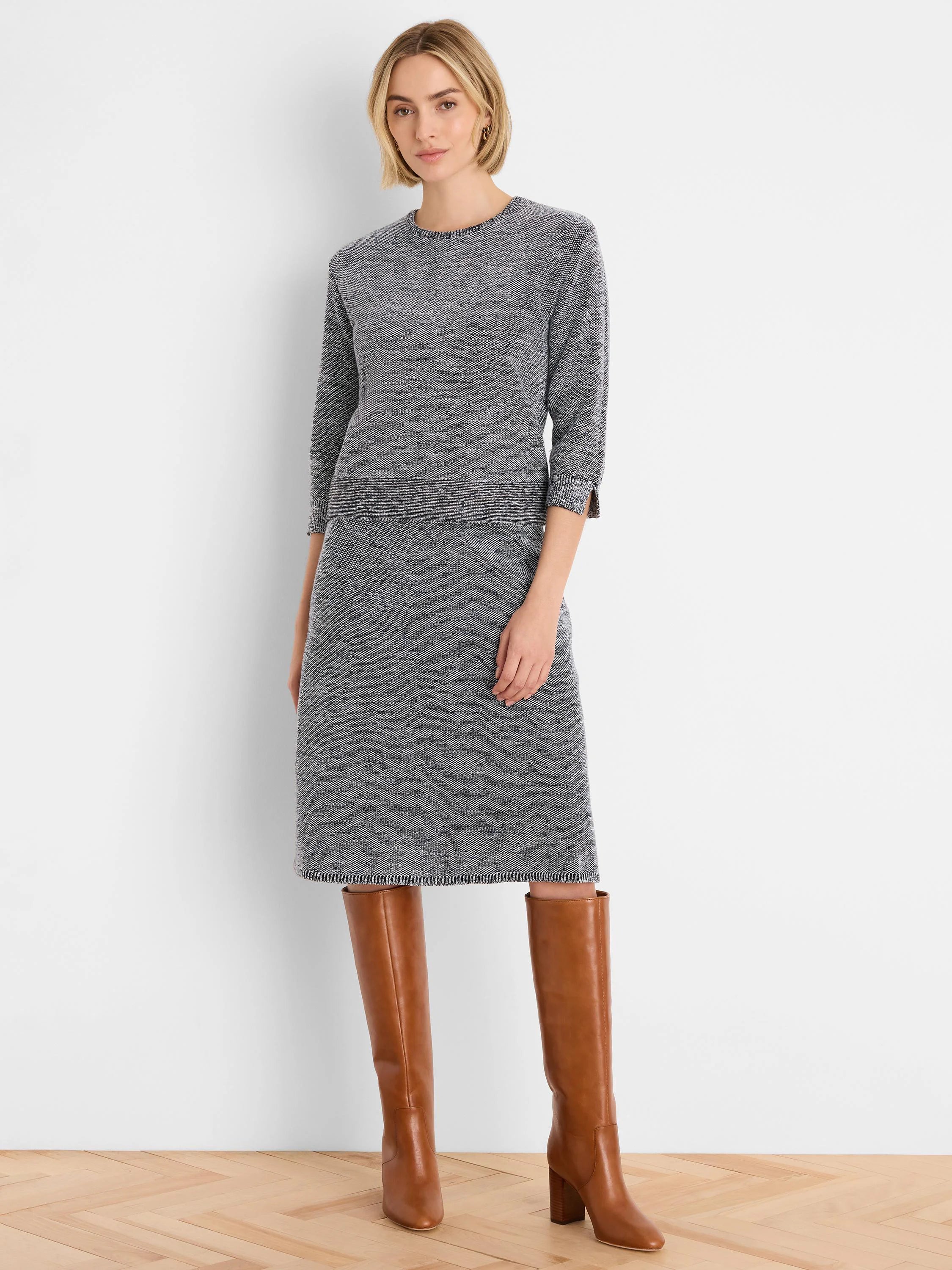 Knee-length marled dark grey and white tweed stitch knit sweater. Round neck, 3/4 sleeves, ribbed waist & slit cuffs.