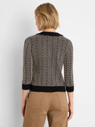 Black & cream geo stitch sweater with lace trim collar, 3/4 sleeves, shown from back.
