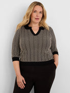 Black & beige geo stitch sweater with 3/4 sleeves, ribbed black cuffs & hem, and a black lace-trim V-neck.