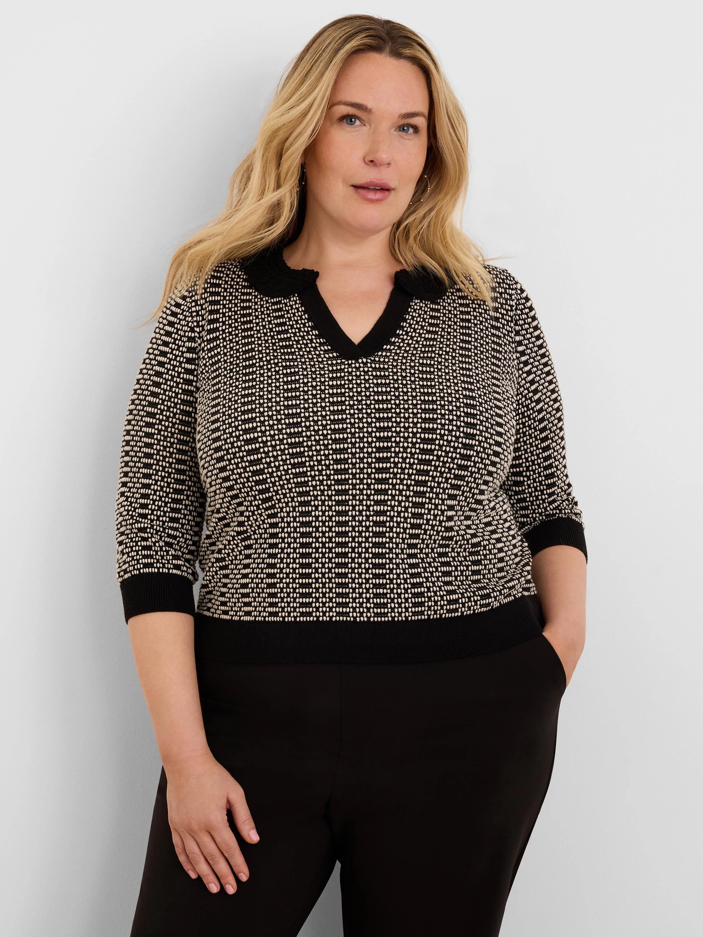 Black & beige geo stitch sweater with 3/4 sleeves, ribbed black cuffs & hem, and a black lace-trim V-neck.
