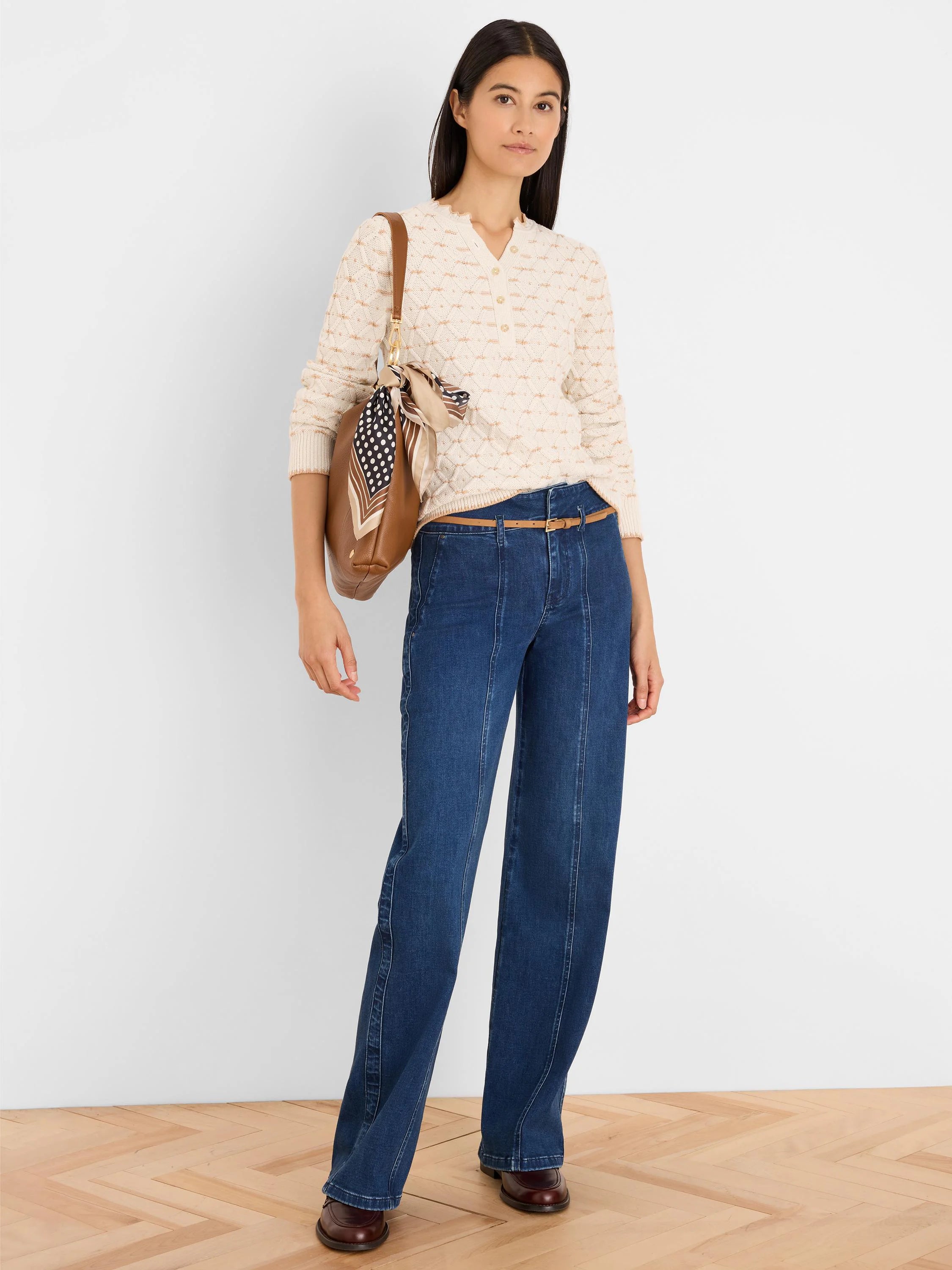Cream cable tuck knit cardigan with V-neck and button front, featuring ribbed cuffs and hem.