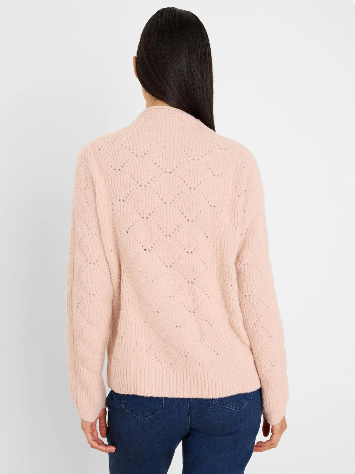 Pale pink sweater with perforated diamond knit, modeled from the back.