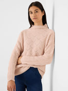 Light pink fuzzy mock neck sweater with diamond knit pattern and ribbed cuffs.